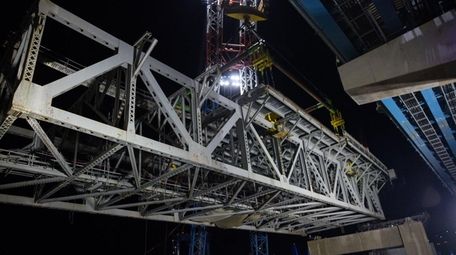 A crane removes a section of the old
