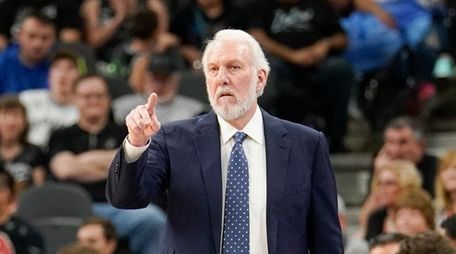 San Antonio Spurs head coach Gregg Popovich signals