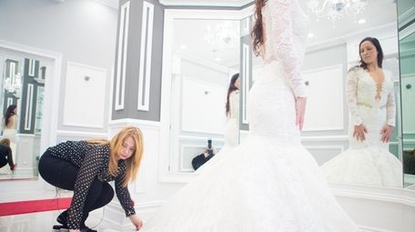 Seamstress Zizi Nasr alters Michelle Fox's dress at