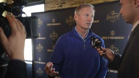 NFL Network analyst Mike Mayock talks with the