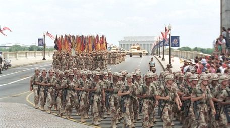 Troops march over the Memorial Bridge in Washington,