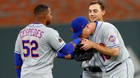 The Mets' Jay Bruce kisses Yoenis Cespedes on
