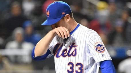 Mets starting pitcher Matt Harvey walks to the