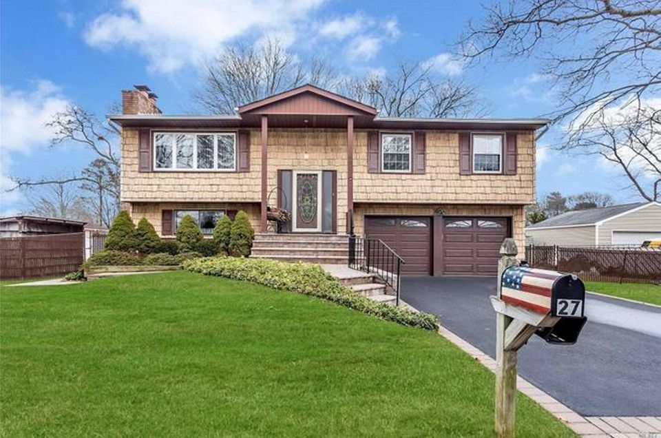 This Sayville high-ranch includes four bedrooms and two