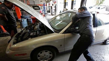 Mechanics Chris Geropoulos, right, and David Galvin work