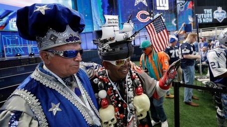 Football fans pose for photos before the first