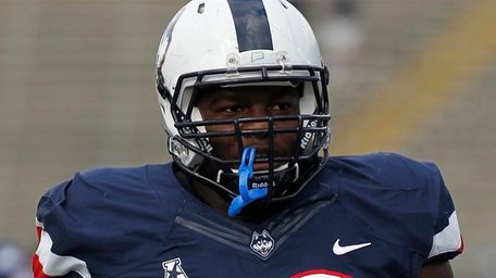 Connecticut defensive lineman Foley Fatukasi stands on the