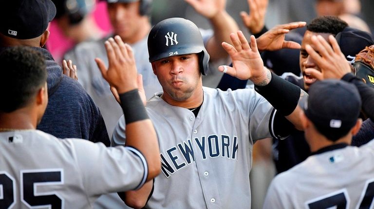 The Yankees' Gary Sanchez is congratulated in the