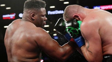 Jarrell Miller, left, punches Johann Duhaupas, of France,