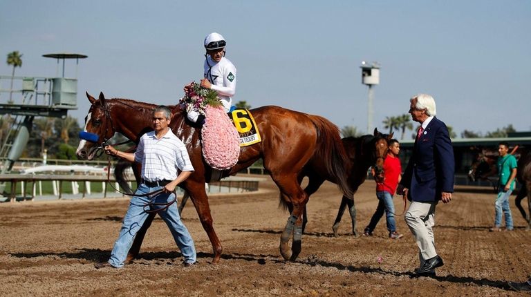 Jockey Mike Smith, aboard Justify, talks to trainer