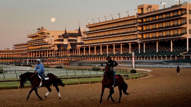 The full moon sets beyond the grandstands at