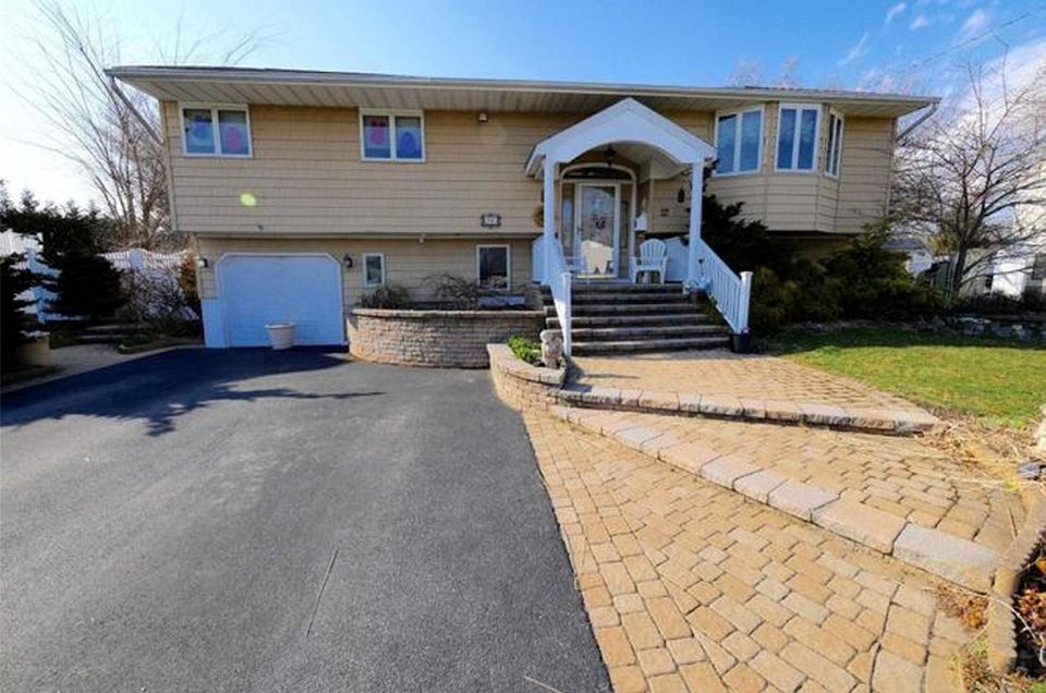 This West Islip high-ranch includes six bedrooms and