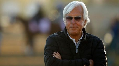 Trainer Bob Baffert watches a morning workout at