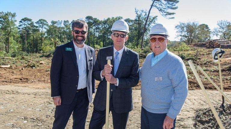 Andy Isakson, center, owner of Isakson Living, with