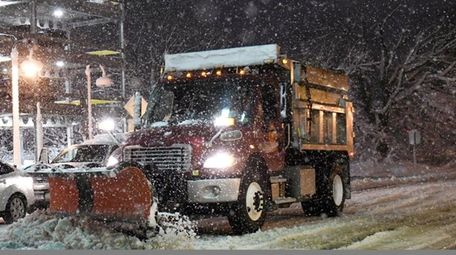 A Brookhaven Town truck plows snow along Railroad