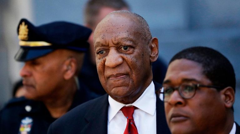 Bill Cosby, center, leaves the the Montgomery County