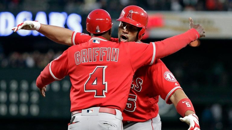 The Angels' Albert Pujols, right, embraces first base