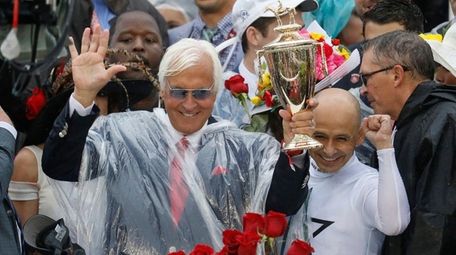 Mike Smith celebrates after riding Justify to victory