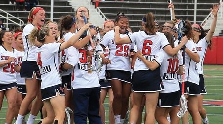 The Stony Brook women's lacrosse team celebrates after