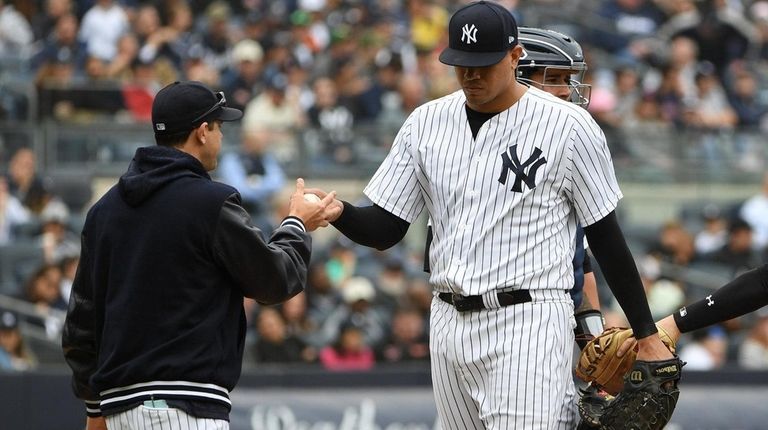 Yankees manager Aaron Boone takes the ball from