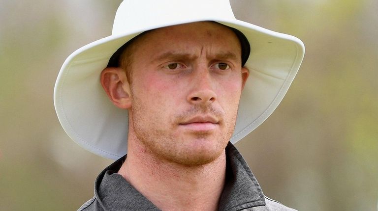 Matthew Lowe walks to the 18th tee during