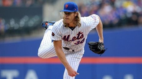 Mets starting pitcher Noah Syndergaarpitches against the Rockies