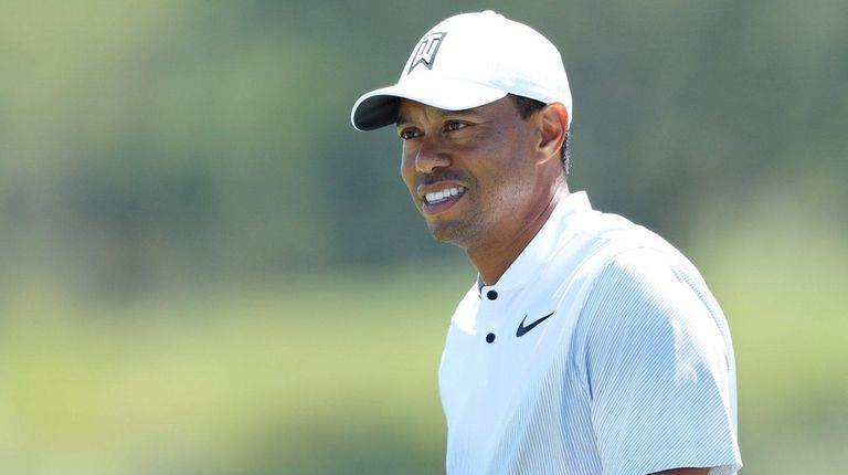 Tiger Woods warms up on the range during