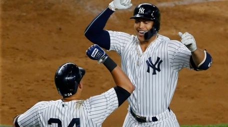 Yankees outfielder Giancarlo Stanton celebrates his fourth-inning home