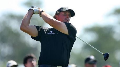 Phil Mickelson hits his tee shot on the