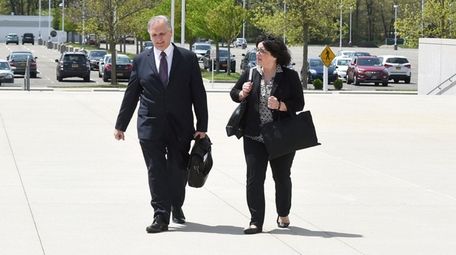 Edward and Linda Mangano arrive at federal court
