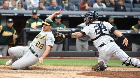 Yankees catcher Gary Sanchez tags out Athletics first