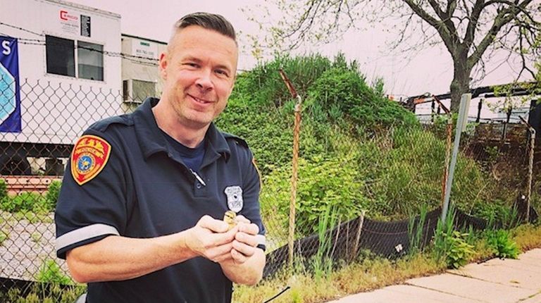 Third Precinct Police Officer Jack Ward holds one