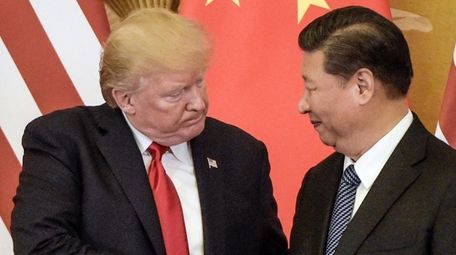 President Donald Trump shakes hands with Chinese President