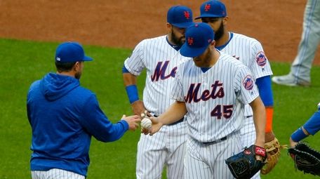 Zack Wheeler of the Mets hands the ball