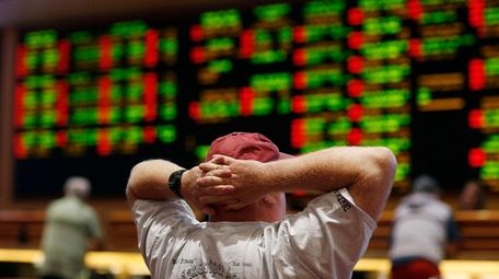 A man watches a baseball game in the