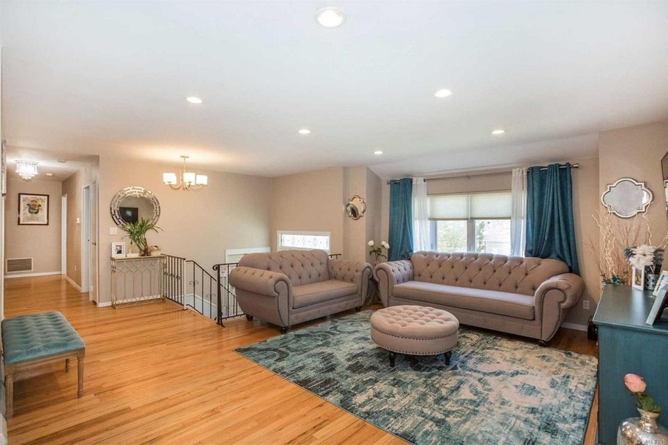 The living room in this Woodmere high-ranch flows
