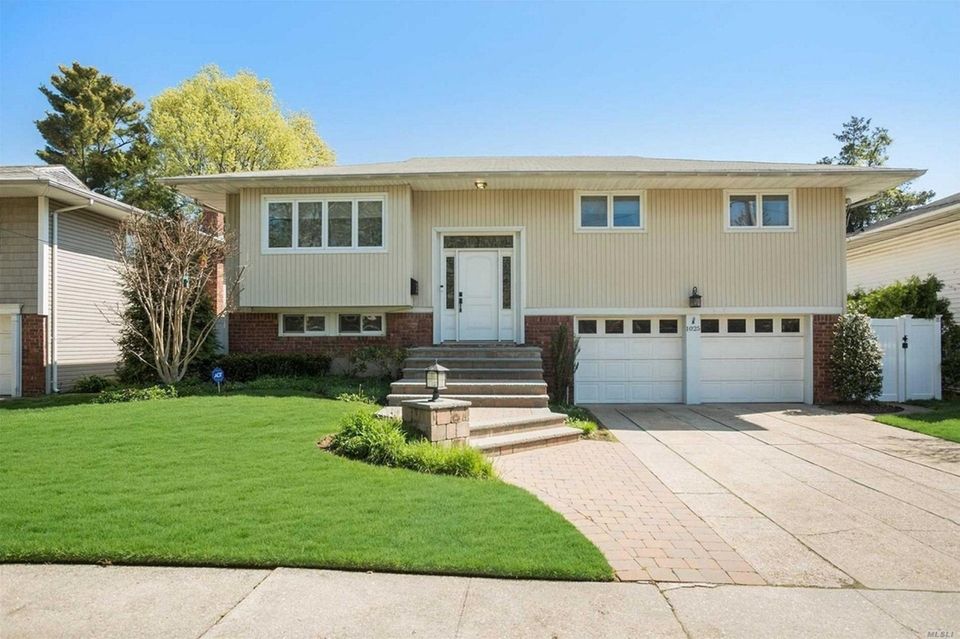 This Woodmere high-ranch includes four bedrooms and 2