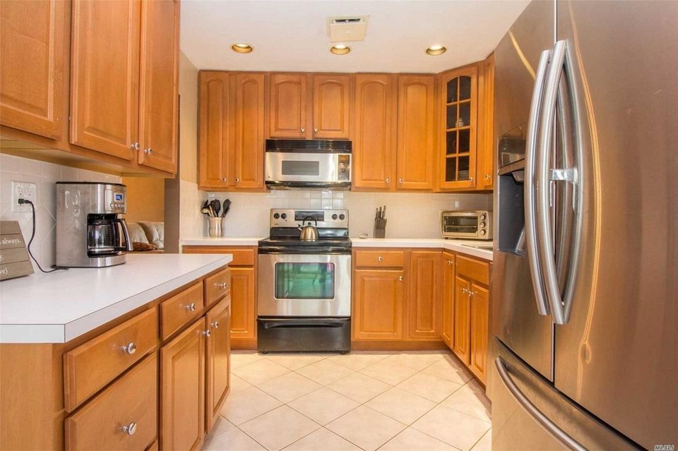 The kitchen in this Commack high-ranch features maple