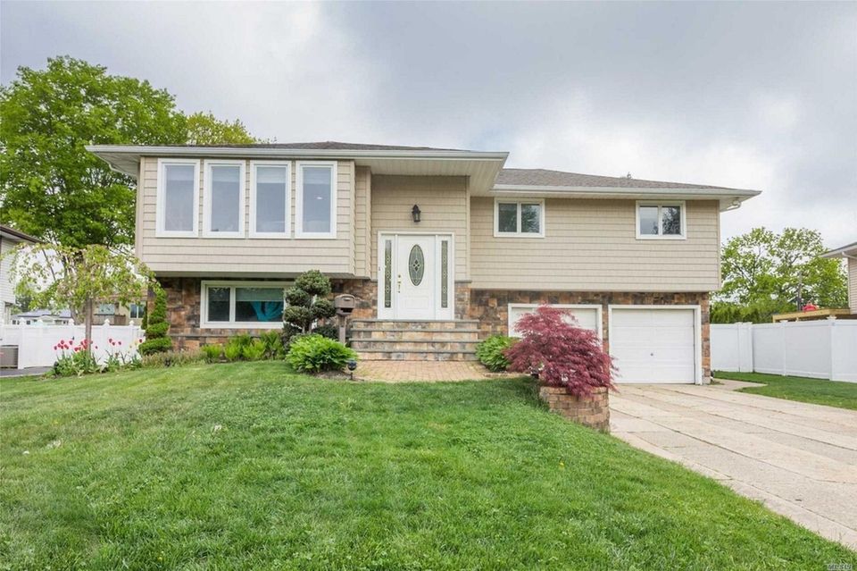 This Commack high-ranch includes four bedrooms and 2