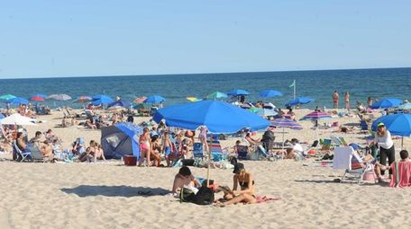 Beachgoers enjoy a late summer day at Coopers