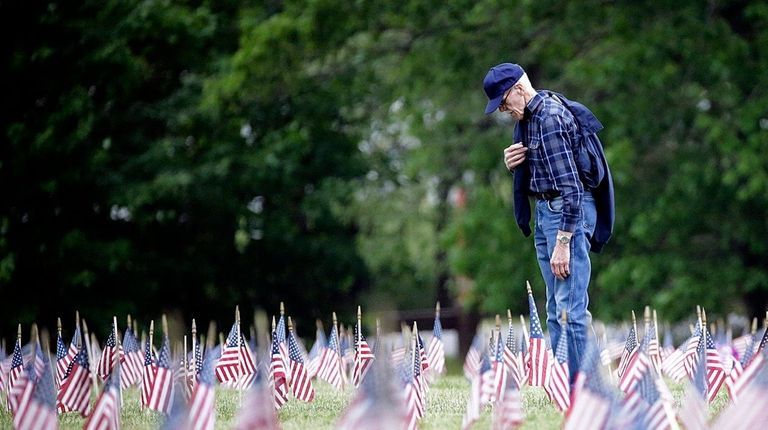 A man says a prayer during the Memorial