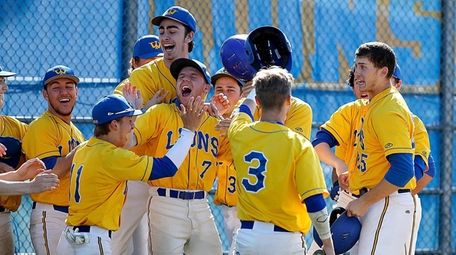 The West Islip bench cheers Tommy Parson (25)