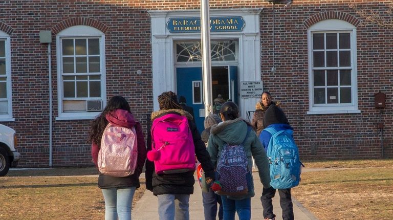 Students arrive at Barack Obama Elementary School on
