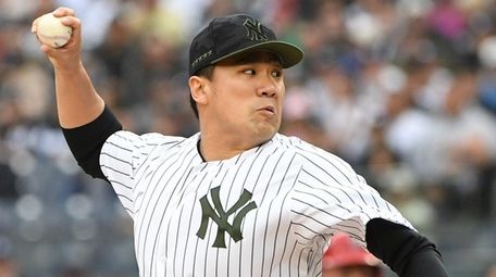 Yankees starting pitcher Masahiro Tanaka delivers a pitch