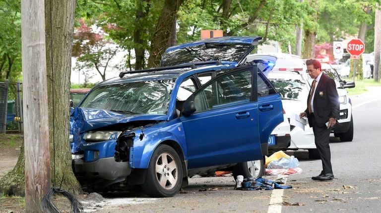 Police investigate the scene of a crash on