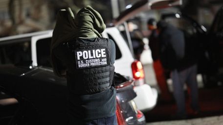 A U.S. federal officer prepares for a night