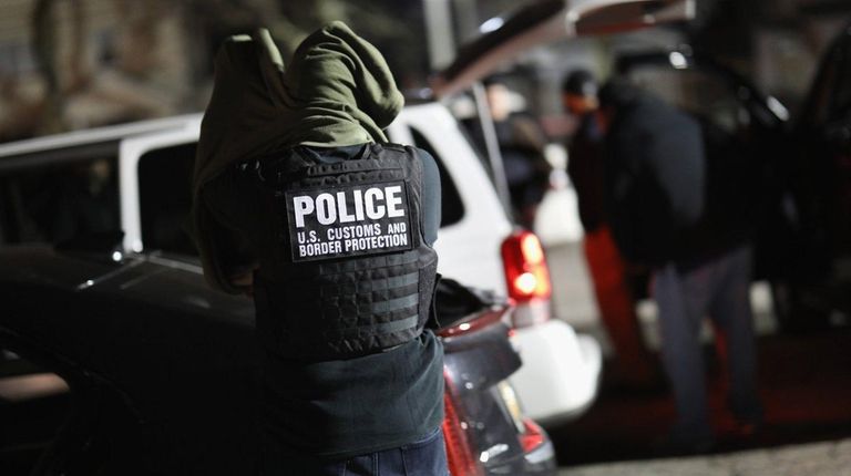 A U.S. federal officer prepares for a night