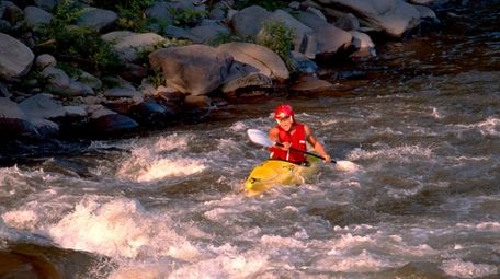 A kayaker paddles on the Esopus Creek.
