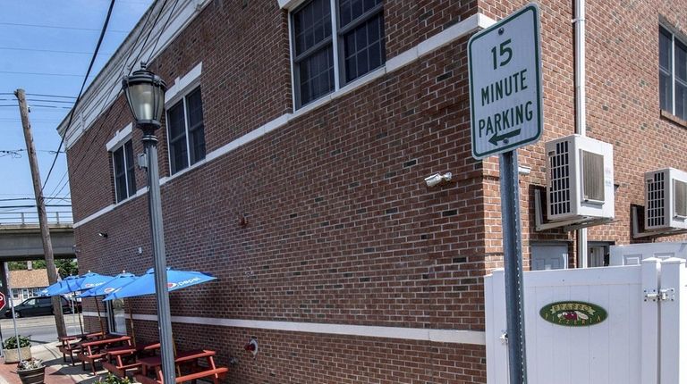 A parking sign outside Spasso Pizzeria at the