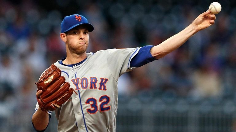 Mets starting pitcher Steven Matz throws to first